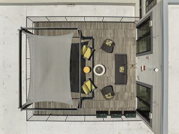 Sun-filled sky deck with pergola and fire pit